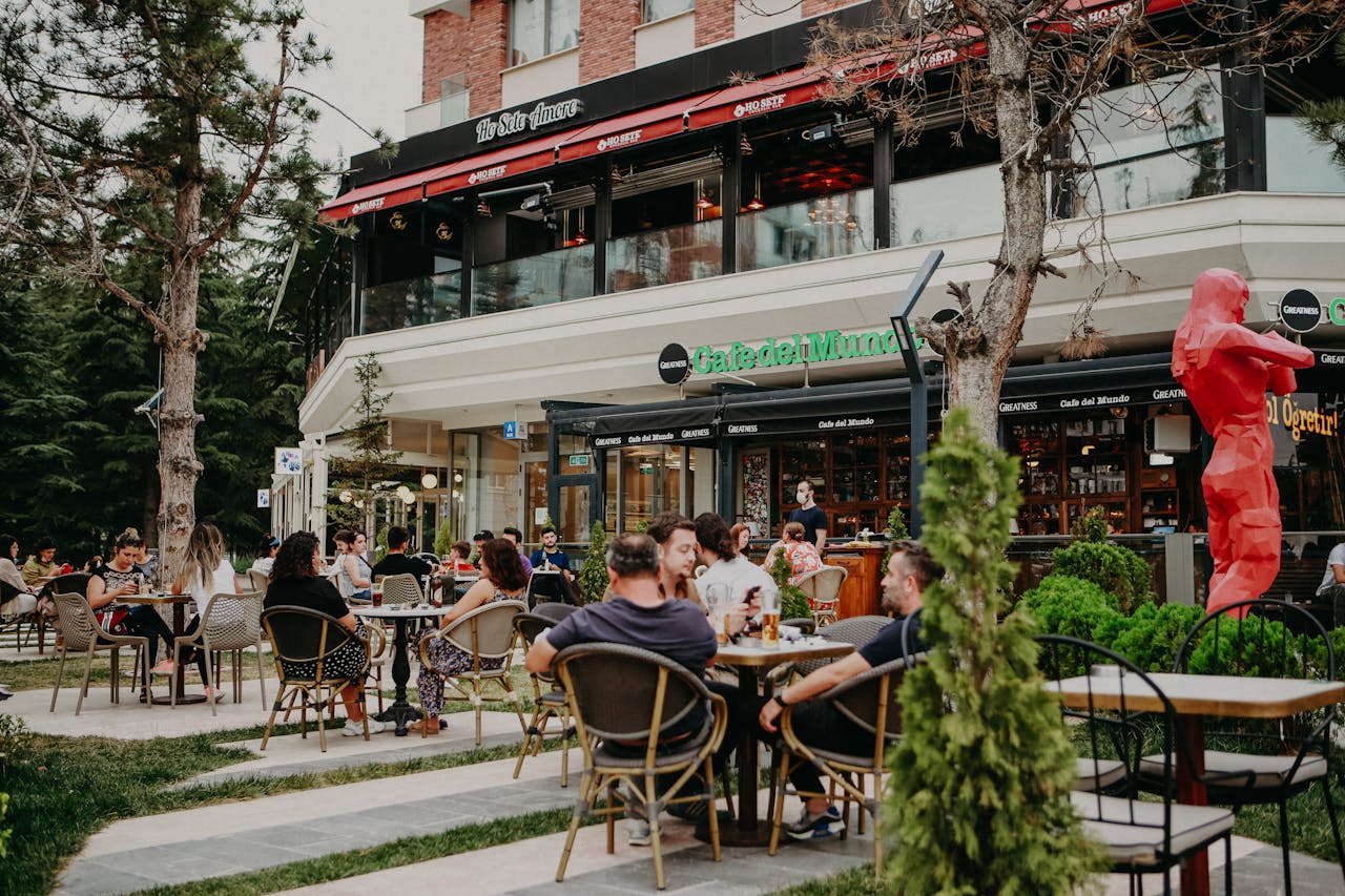 Charming outdoor cafe with stylish seating on a sunny day, perfect for a relaxing afternoon.
